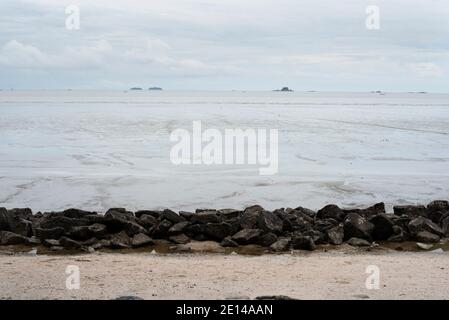 Landscape view of a muddy beach at low tide Stock Photo