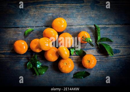 Several Mandarin Oranges On A Wooden Table Stock Photo