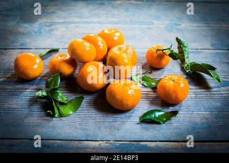 Several Mandarin Oranges On A Wooden Table Stock Photo