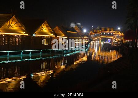 The structures of the Gaozhuang night market and specifically its shopping street are interesting architecturally and lit in brilliant colors Stock Photo