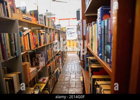 Observatory -  Cape Town, South Africa - 02/12/2020  Row of book shelfs packed with colorful assortment of books, in a quite book store. Stock Photo