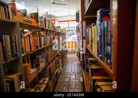 Observatory -  Cape Town, South Africa - 02/12/2020  Row of book shelfs packed with colorful assortment of books, in a quite book store. Stock Photo