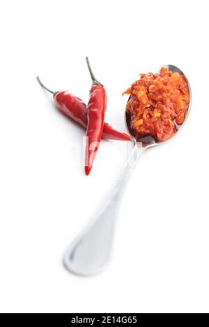 Red hot chili paste in spoon isolated on white background. Stock Photo