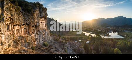 Aerial panoramic view of sunrise over ancient Lycian rock tombs near the town of Dalyan, Muğla province, Turkey