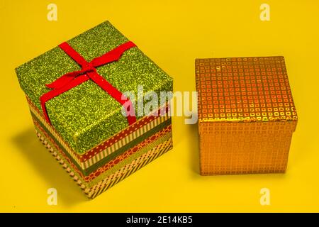 Two Christmas Gift Boxes On Yellow Background Stock Photo