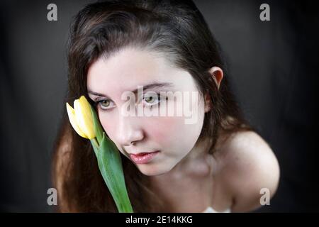 teenager with tulip in hand Stock Photo