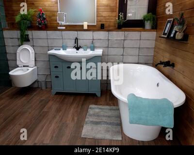 Modern bathroom interior with large bathtub. Wood and tile finishes. Stock Photo