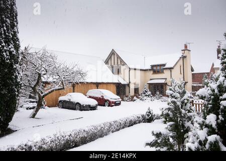 UK, England, Cheshire, Congleton, arts and crafts style house and triple garage covered with snow in winter Stock Photo