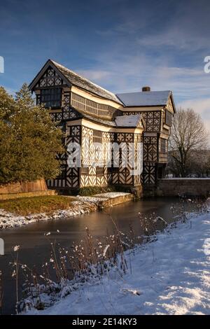 UK, England, Cheshire, Scholar Green, Little Moreton Hall, timber-framed Tudor Farmhouse, in winter, from moat Stock Photo