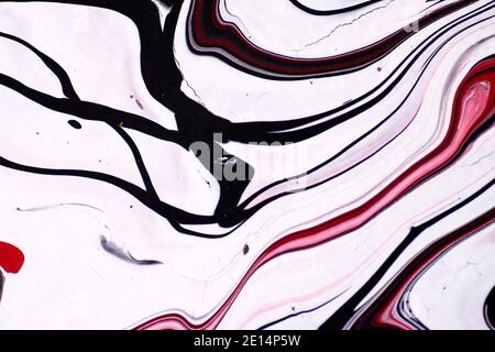 Marbled acrylic colored pattern in the colors red, black, white and ...