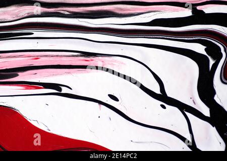 Marbled acrylic colored pattern in the colors red, black, white and pink. Stock Photo
