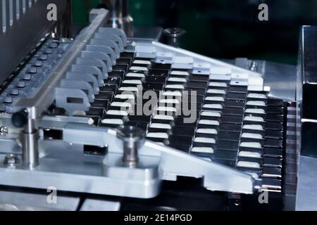 pharmacy medicine capsule pill in production line at medical factory. selective focus. pharmaceutical manufacturing and industry concept. Stock Photo