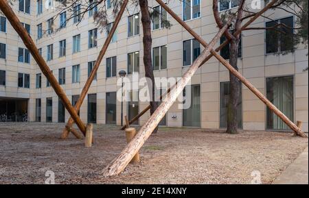 Wooden Post Supports A Tree In The City Stock Photo