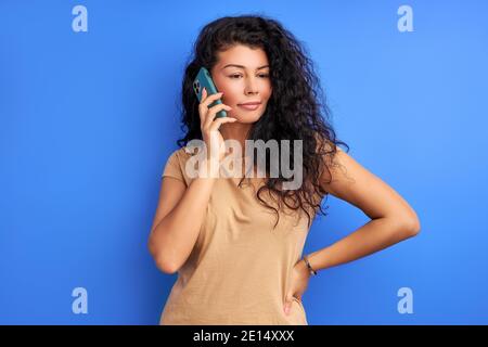 gorgeous woman listen to talk on phone, having conversation, looking at side Stock Photo