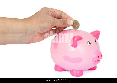 Hand Throwing Euro Coin Into A Piggy Bank Stock Photo