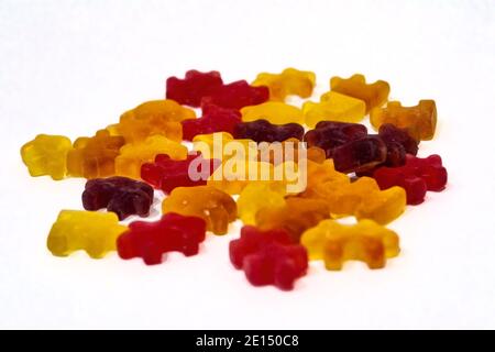 Multicolored chewy figured marmalade in the form of puzzles isolate on a white background close-up. Stock Photo