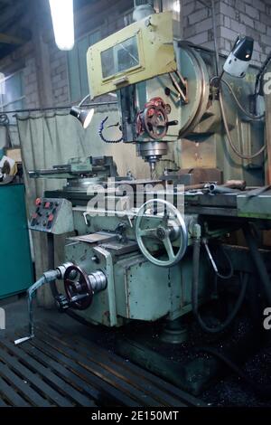 closeup of metallic lathe drilling against factory industrial interior background, nobody Stock Photo