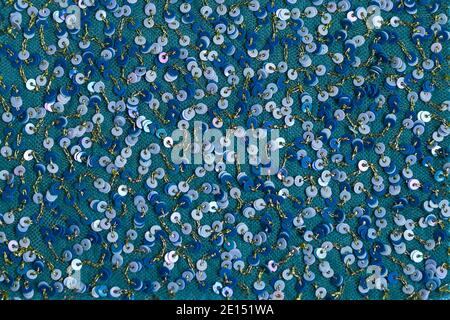 Beautiful shiny background of blue sequin. Fabric background made of blue shiny circles. Stock Photo