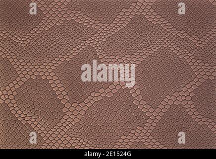 Light brown leather texture background with pattern, closeup. Reptile skin. Beige skin of a crocodile or a snake with vignette. Leatherette. Stock Photo