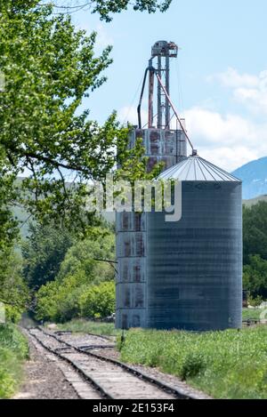 Grain elevator and bin next to railroad tracks, Wallowa Valley, Oregon. Stock Photo