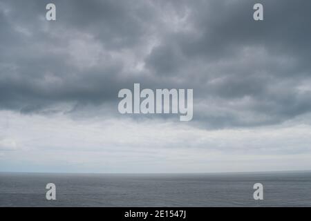 View of the Sea Beneath Dark Clouds from the Isle of Portland in Dorset Stock Photo