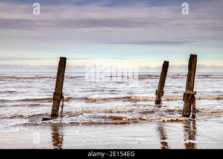 Wooden groynes on Prestatyn Beach, North Wales Stock Photo