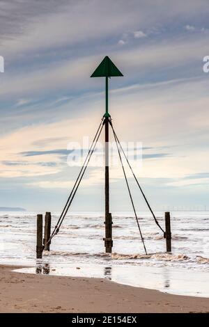 Marker post on Prestatyn Beach, North Wales Stock Photo