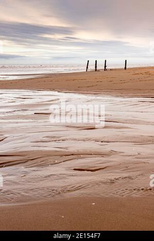 Wooden groynes on Prestatyn Beach, North Wales Stock Photo