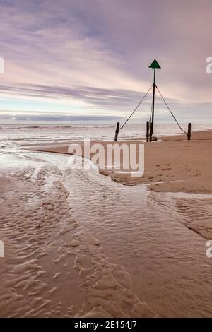 Marker post on Prestatyn Beach, North Wales Stock Photo