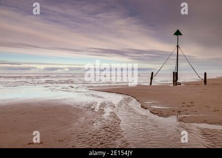 Marker post on Prestatyn Beach, North Wales Stock Photo