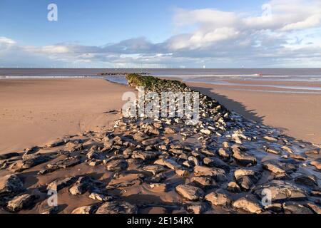 Breakwater and offshore turbines, Prestatyn Beach, North Wales Stock Photo