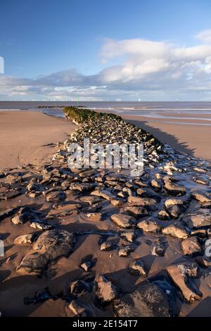 Breakwater and offshore turbines, Prestatyn Beach, North Wales Stock Photo