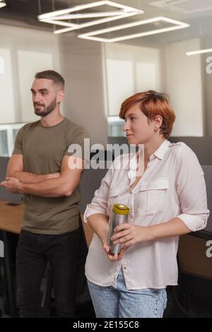 Vertical shot of young people having coffee break at the office Stock Photo