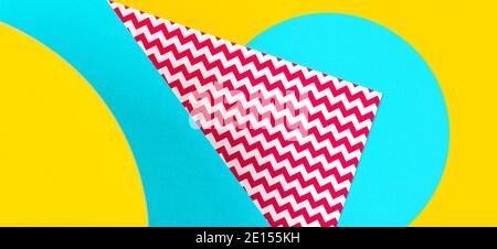 Abstract geometric fashion papers texture background in yellow, red, blue colors and zigzag pattrn. Top view, flat lay Stock Photo