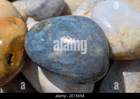Beautiful Blue Stone on Chesil Beach in Dorset Stock Photo