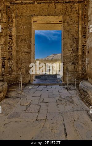 Looking towards the outer mud brick wall. through the ruined columns of the Great Hypostyle Hall in the Temple of Ramses III at Medinet Habu Temple Stock Photo