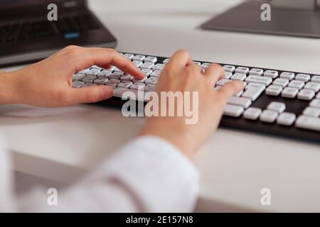 Close up of the hands of a businesswoman typing on computer keyboard Stock Photo