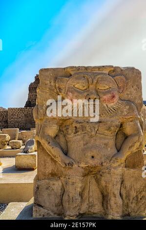 Painted Sandstone Relief of the Lionheaded dwarflike God Bes from the Roman Birth-house in the Dendera Temple complex Stock Photo