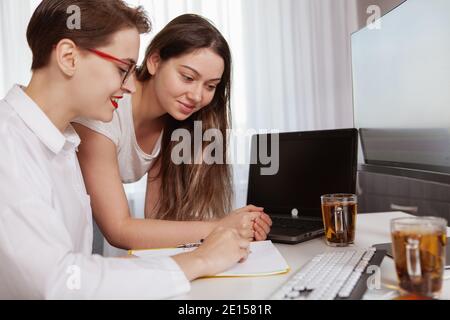 Two young female business colleagues working together on a project. Software developers working on a project together Stock Photo