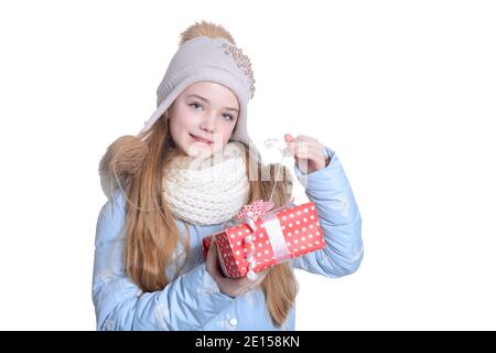 Happy little girl in warm clothes holding gift box Stock Photo