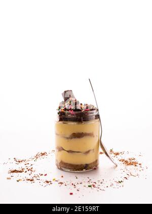 Tiramisu is a coffee-flavored Italian dessert. Tiramisu dessert in jar with chocolate topping and white background Stock Photo