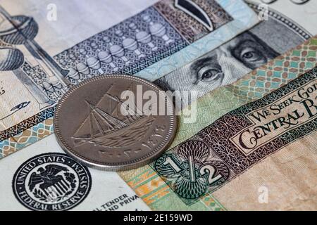 100 fils on 100 dollar and Kuwaiti Dinar banknotes background Stock Photo
