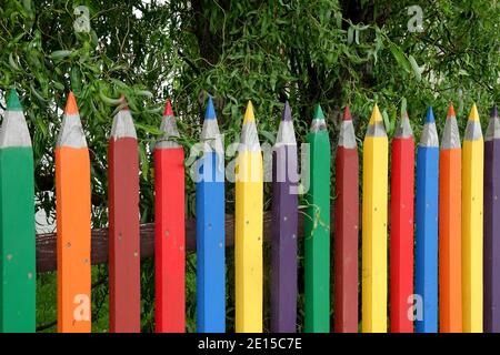 Colorful fence of pencils wooden fence garden Stock Photo