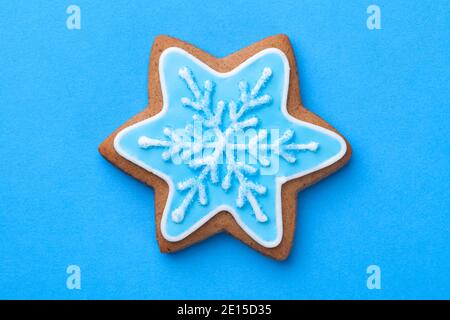 Beautiful christmas gingerbread cookie in shape of star with snowflake over blue background Stock Photo