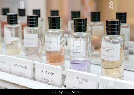 Moscow, Russia - December 15. 2020: Set of colorful perfume bottles in shop window in GUM departmed store on Red square. Stock Photo