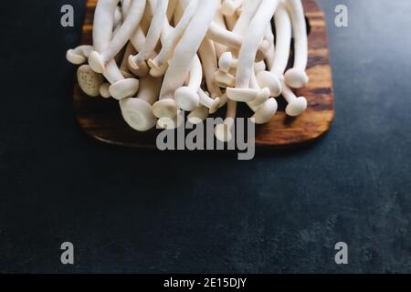 Cooking white mushrooms on the dark gray background Stock Photo