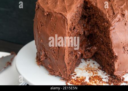 Chocolate Stout Cake with Chocolate Bourbon Sour Cream Frosting: A sliced chocolate cake with three layers Stock Photo
