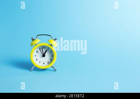 Mechanical alarm clock on the blue background Stock Photo