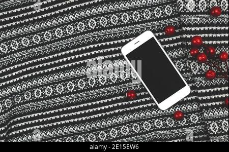 Knitted sweater background with red decoration, blank white smartphone, copy space cozy banner. High quality photo Stock Photo