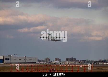 Montreal, Quebec/ Canada - 11/29/2020 : Air Canada's Embraer E175 with old blue livery, taking off from Montreal Intl. Airport. Stock Photo